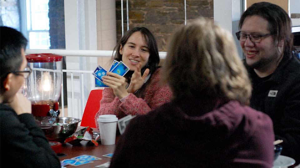Ubisoft Halifax teammates sitting at a table playing a card game